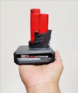 M12 lithium-ion battery has 5.0 Amp Hour capacity. This high output XC5.0 model is black and red with a wide base for stability. It is compatible with