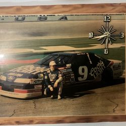 Bill Elliott laminated wooden clock runs off of a three a battery works very well