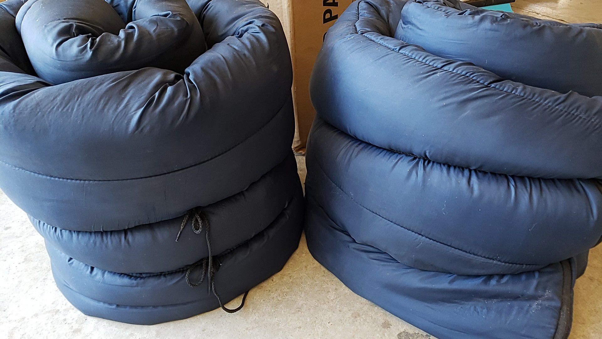 2 navy blue Coleman sleeping bags