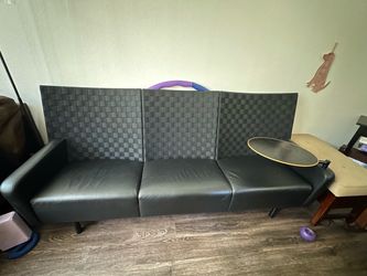 Contemporary black leather sofa with side table