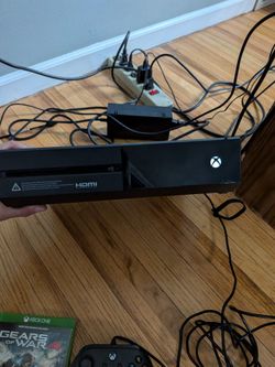 Xbox one comes with 1 wired controller 1 wireless gears of war and all cables