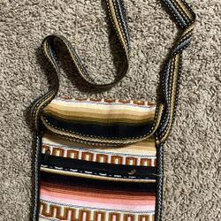 Artisan woven textile crossbody bag with a fringe