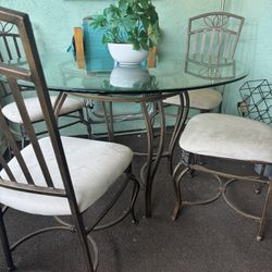 Beautiful Bronze and Glass top Dining Table With Four Bronze and White Cushion Seats. 48” Dia