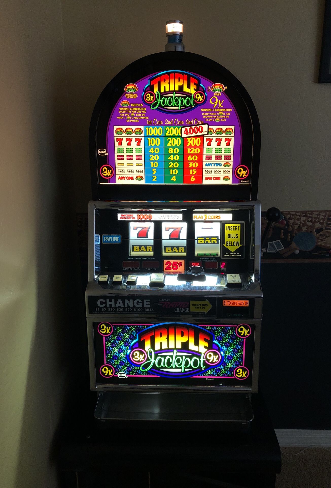 An IGT Triple Jackpot quarter slot machine and a Bally’s Wild Rose quarter slot machine.