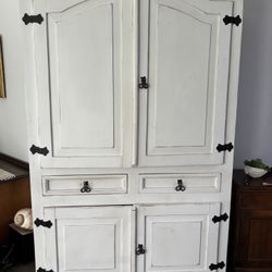 Deep Armoire with lots of storage, hanging rod & spacious drawers.  Solid wood . A substantial piece  for bedroom , family room or entrance!