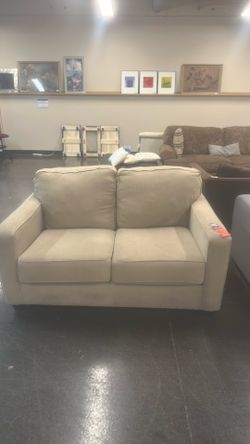 Basette white loveseat with pillows