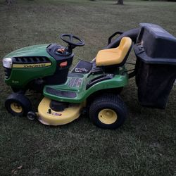 John Deere riding lawnmower with bagger attachment