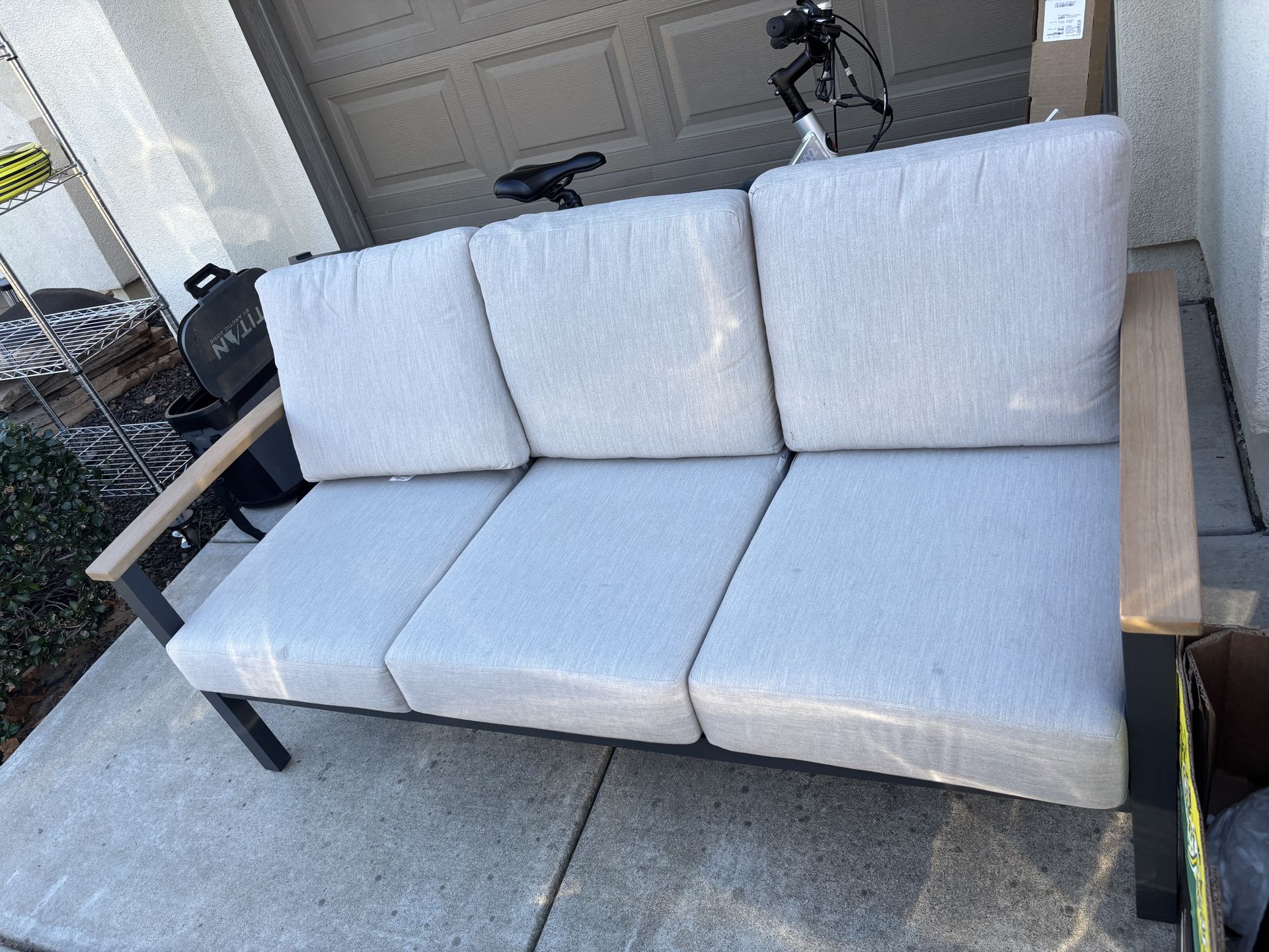 Outdoor patio furniture, two chairs, sofa, and a table