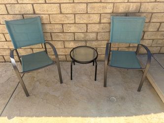 Two mesh chairs and side table