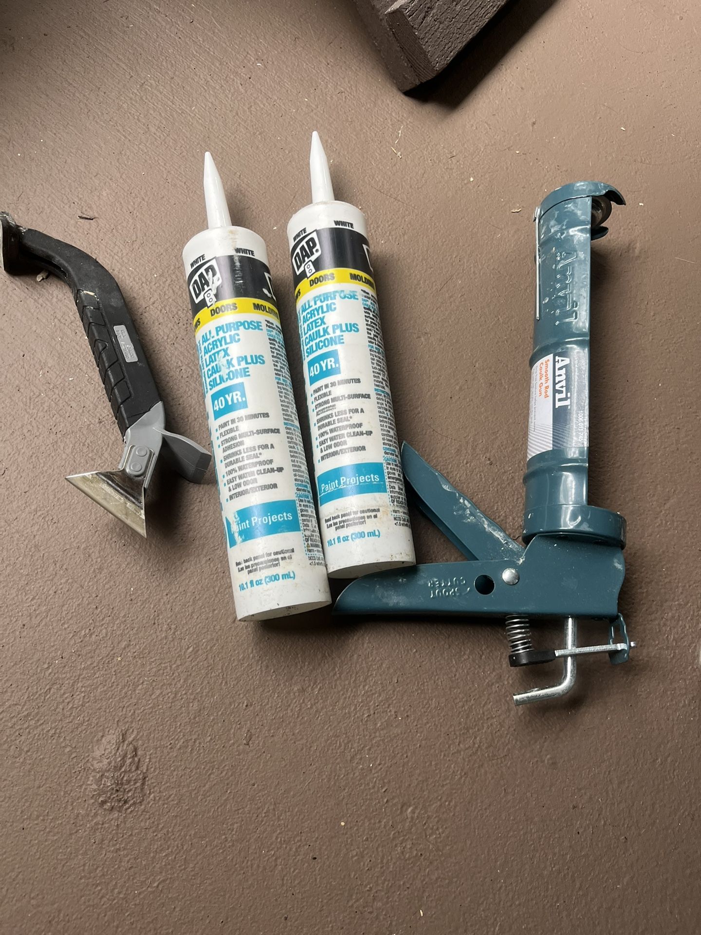 Caulk with gun and tool