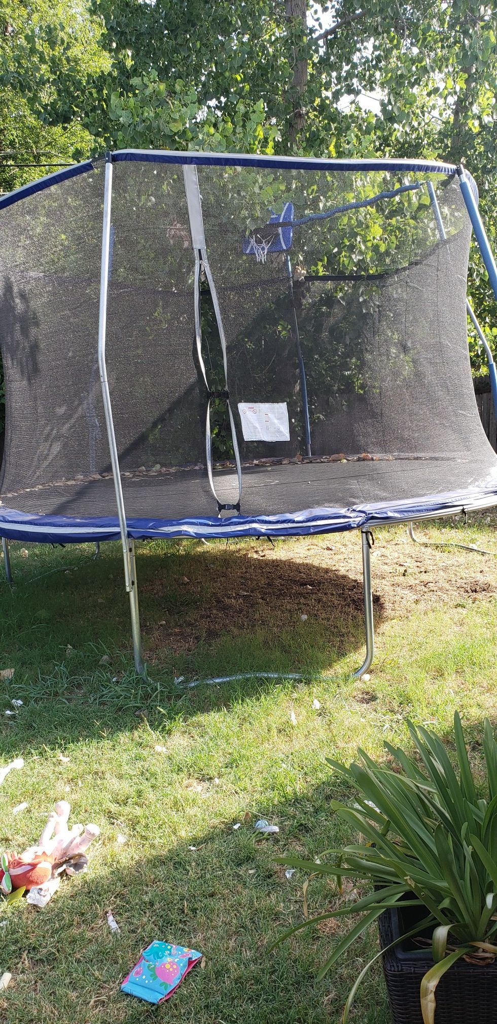 Trampoline with safety net and mini basketball hoop