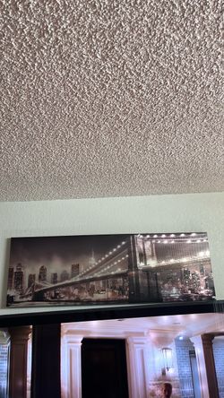 panoramic canvas print of the Brooklyn Bridge and New York City skyline at night.