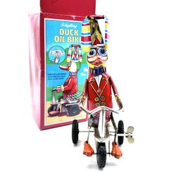 8 inch duck on a bike wind up tin toy by Schylling.