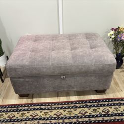Upholstered gray ottoman