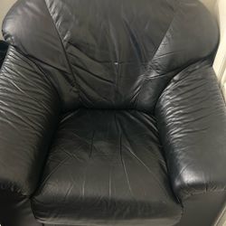  black  leatherchair  and ottoman. 