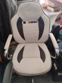 Two chairs One gaming chair with no wheels on it and the other is the office chair White that looks really well no tears everything good on it