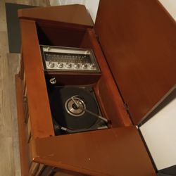 Hello, I'm selling a piece of furniture with a record player included. It's an antique piece of furniture, $150. The price is negotiable.