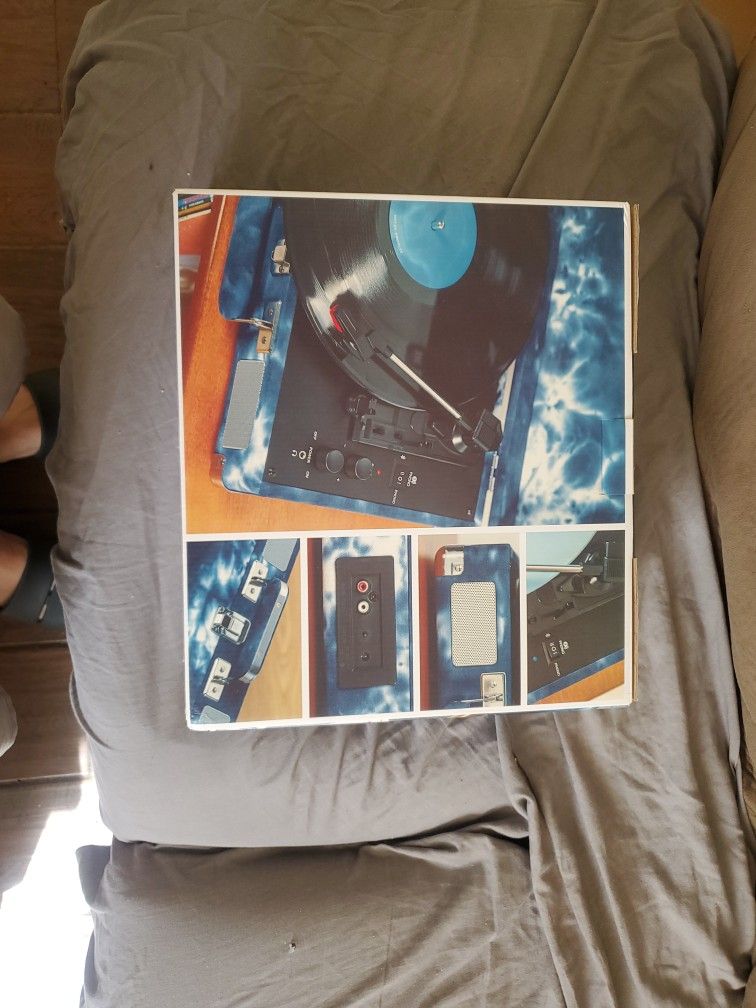 Portable Turn Table. Used 2 Times. Includes 4 Vinyl Records 