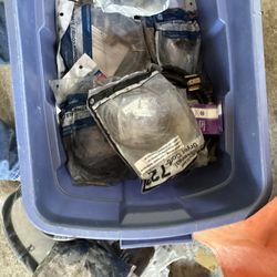 bin filled with packaged appliance power cords, washer, dryer cords, etc. 