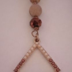 Necklace With A Double Triangle Pendant With Beads