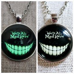 18" Glow-In-The-Dark We're All Mad Here Chesire Grinning Cat 1" Pendant Necklace. Silver Toned Chain. Fashionable Costume Jewelry. New! 

Makes a grea