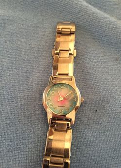 Silver tone watch with pink, blue and hearts in face