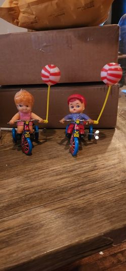 Vintage girl and boy wine up toys.