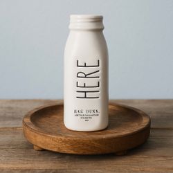 Rae Dunn China 2010s “Here” White Ceramic Bottle Vase, 1.5 x 6”
