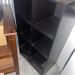 Black vertical cube with drawer at the bottom