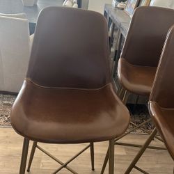 Three World Market Leather Stools. 