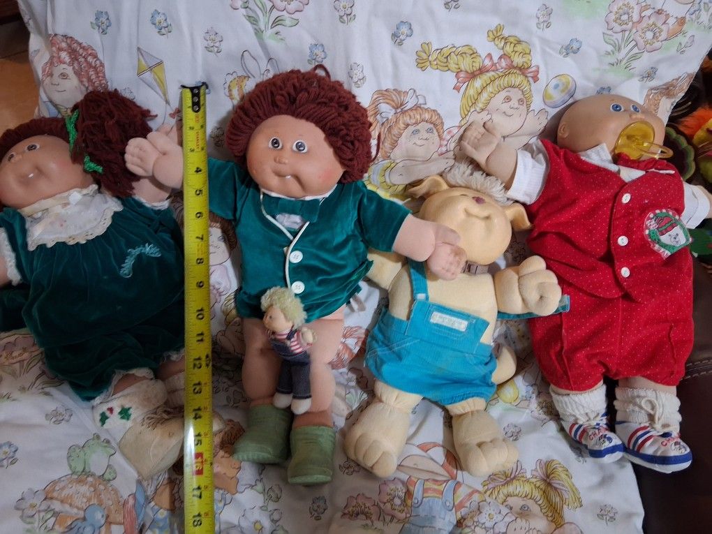 Collection of cabbage, patch dolls and blanket.