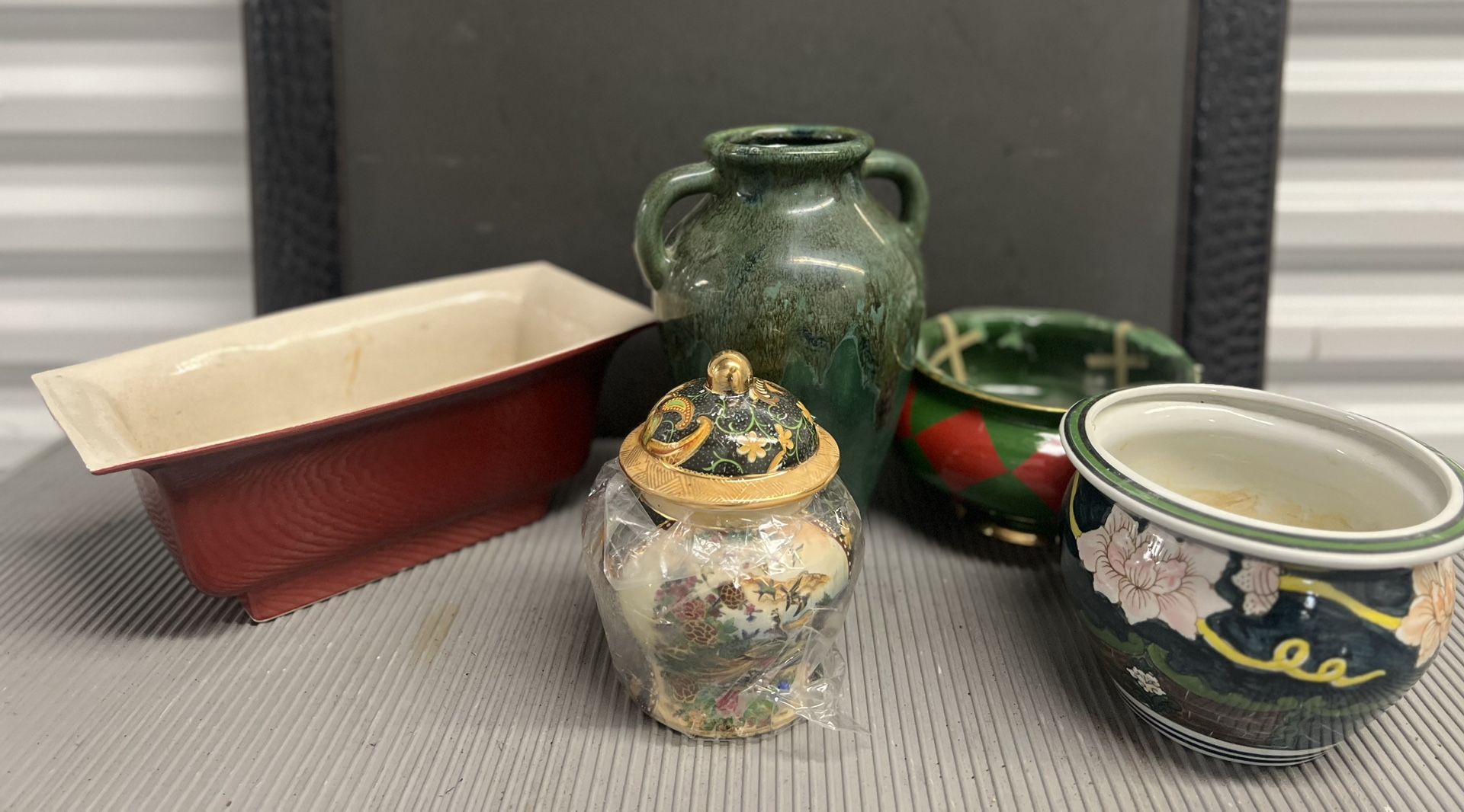 An Assortment Of Flower Pods, Vases Bowls, And Small Artistic Pieces