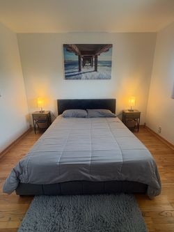 Queen size bed frame with bedside table and lamp