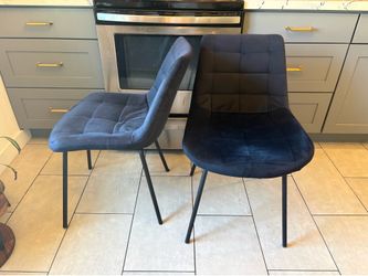 Two black velvet dining chairs