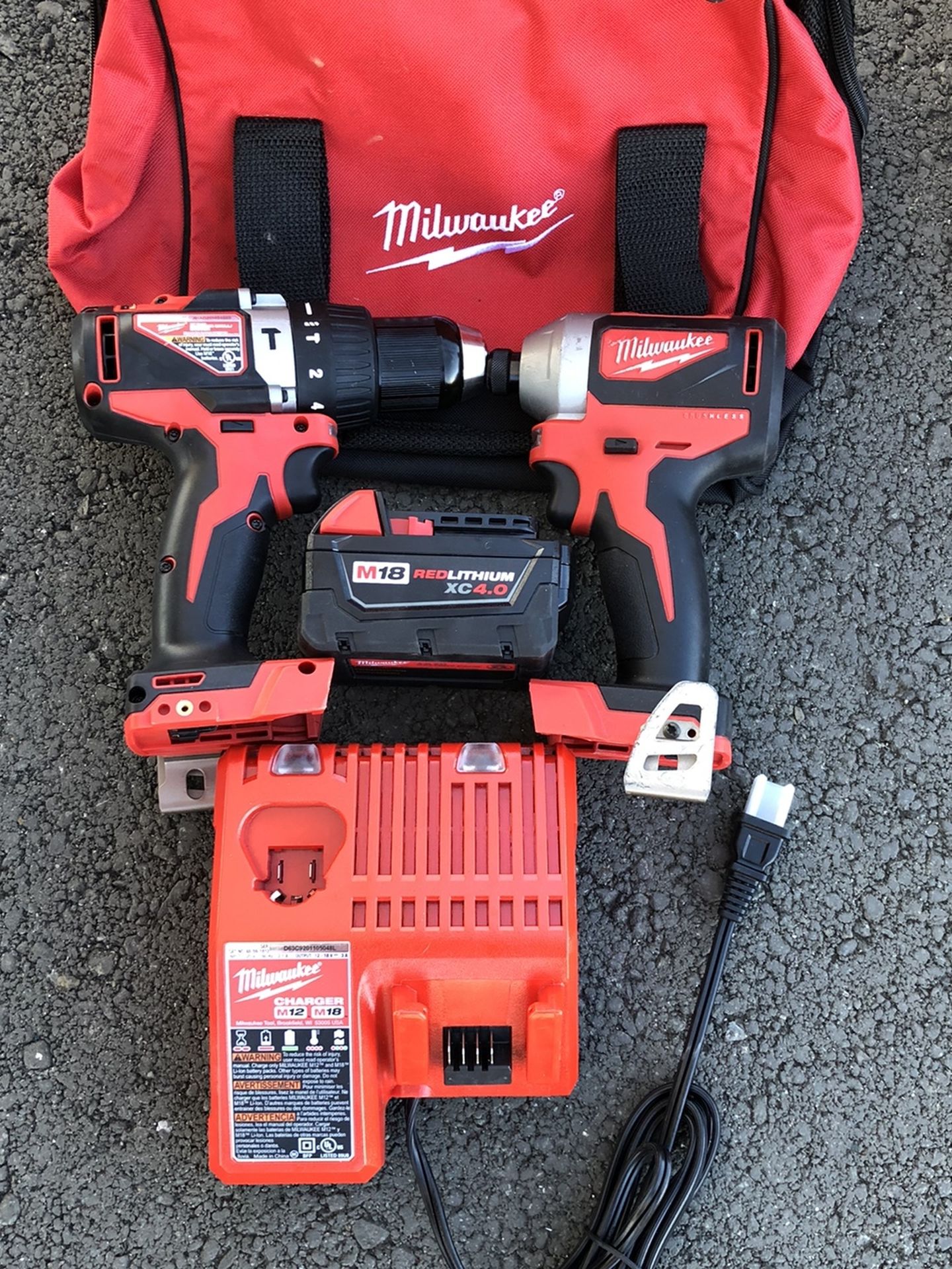 MILWAUKEE COMBO DRILLS WITH ONE BATTERY AND CHARGER BRAND NEW WITH BACKPACK BRAND NEW
