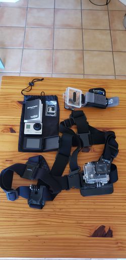GoPro camera, 2 GoPro Water Proof cases and harnesses,