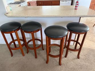 4 Wooden Bar Stools with Black Cushioned Seats
