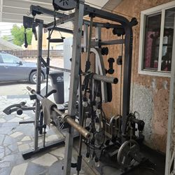 Used GOLD'S GYM smith Machine N Olympic Bar / Pull System / Bench w Arm Curl Pad. 