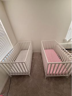 White cribs & mattresses (2)