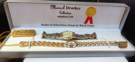 Marcel Drucker Collection watch set features a silver-tone analog timepiece and a matching two-tone bracelet.