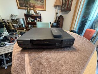Functional Toshiba M-45 VHS VCR is black and grey. This unit has a 4-head cleaning system and digital tracking. It comes with a matching remote contro