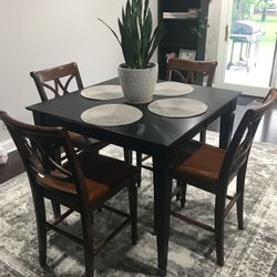 Tall Ebony wood table with 5 chairs and leaf.