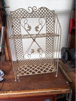 Vintage 1960s folding wrought iron plant stand / magazine rack with lattice and fleur-de-lis design.
