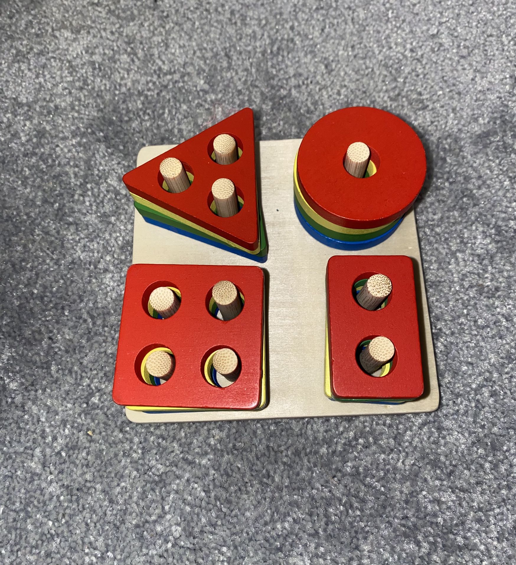 Wooden shape sorting toy with pegs 