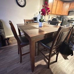 Wood/Tall dining room table with 4 chairs