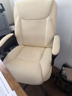 Comfortable cream office chair with armrests.