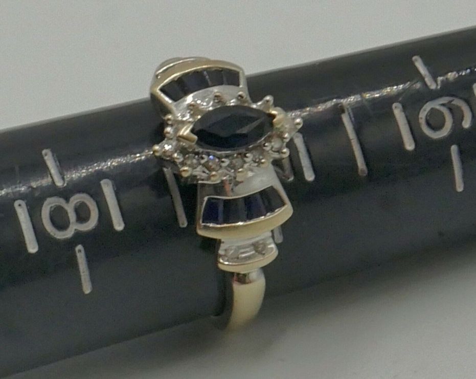 14kt white gold ladies fashion ring with blue stones and diamonds 0.15 carat total weight 2.7 gr size 7. 843184-4. Pre owned