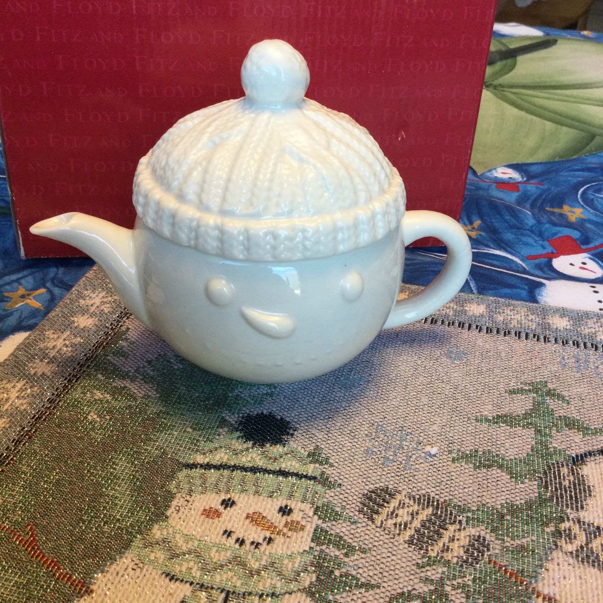 Small snowman face with hat tea pot.