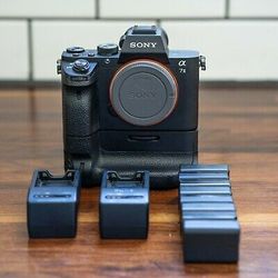 Sony A7II, Sony VG-C2EM Battery Grip, Two Sony Chargers, Eight Batteries