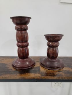 Pair of traditional metal candlesticks made in India with a dark brown, antiqued finish and a twisted design.